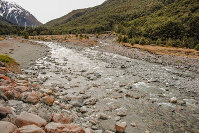 Surface level of road by land against sky