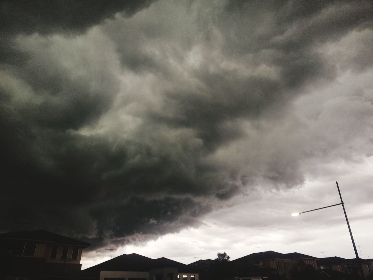 LOW ANGLE VIEW OF STORM CLOUDS OVER CITY