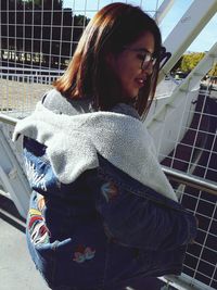 Young woman sitting in corridor