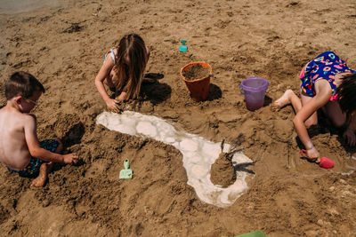 Children digging in sand on a sunny day at the beach