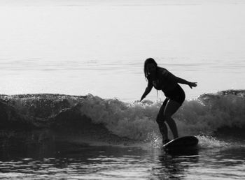 Woman surfing on sea