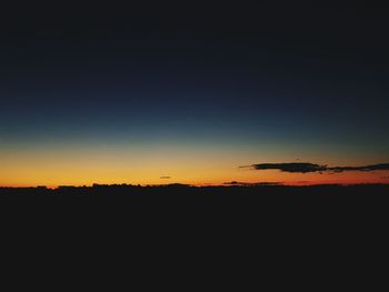 Silhouette landscape against clear sky during sunset