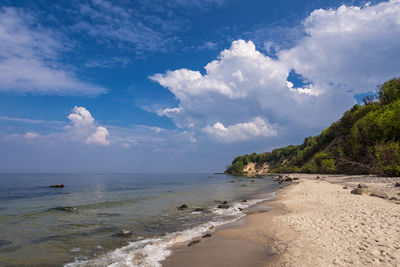 View of beach against cloudy sky