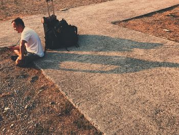 High angle view of man sitting outdoors