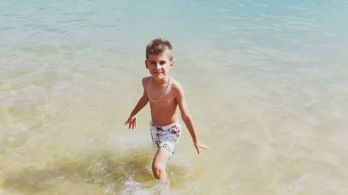 High angle portrait of shirtless boy in sea