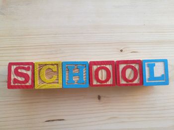 School text made from multi colored letter blocks on table