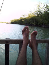 Low section of woman relaxing on water