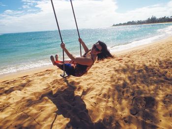 Woman on beach swing