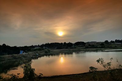 Scenic view of lake against sky during sunset