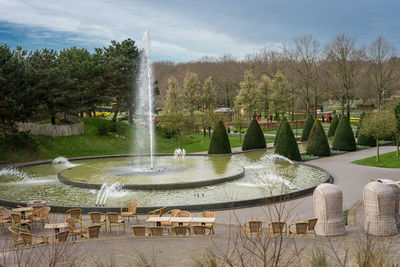 Fountain in park against sky