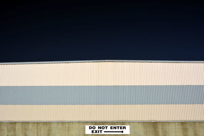 Road sign against clear sky