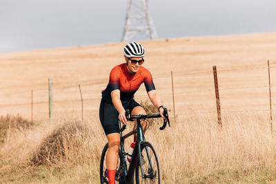 Man riding bicycle on field