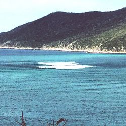 Scenic view of sea with mountains in background