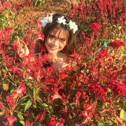 Portrait of woman with red flowers