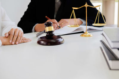 Close-up of man holding camera on table
