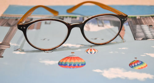 Close-up of sunglasses against sky