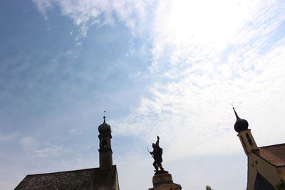 Low angle view of statue of historic building against sky