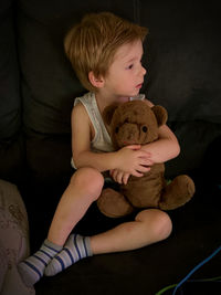 Full length of girl sitting with toy