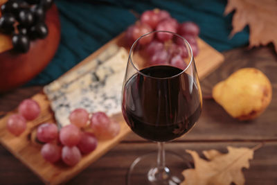 Midsection of woman holding wineglass