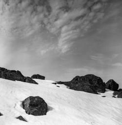 Rocks on land against sky during winter