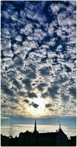 Low angle view of built structure against cloudy sky