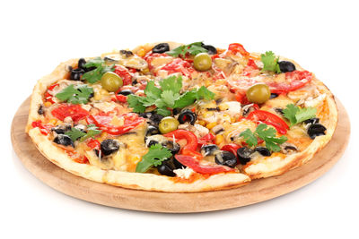 Close-up of pizza served in plate against white background