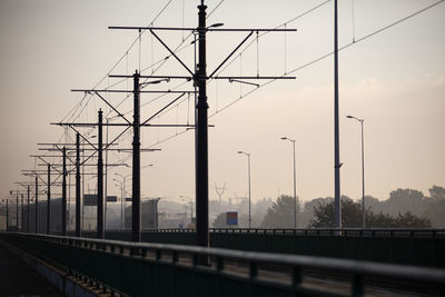 Railroad tracks against sky during sunset