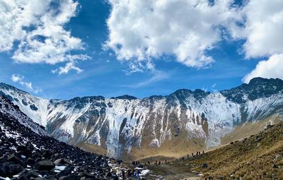 Panoramic view of a valley with snowcapped mountains against sky