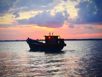 Ship on sea against sky during sunset