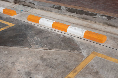 High angle view of cigarette on floor against wall