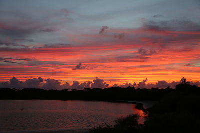 Scenic view of lake against orange sky