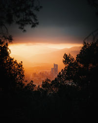 Scenic view of city against sky during dramatic sunset