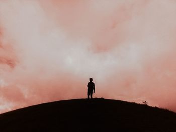 Rear view of woman photographing against sky