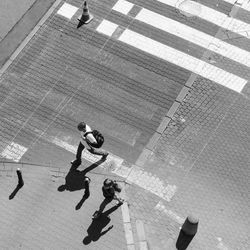 High angle view of woman standing on tiled floor