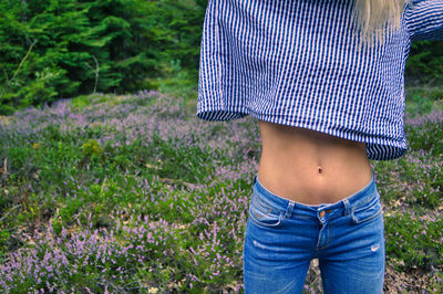 Midsection of sensuous woman standing on land