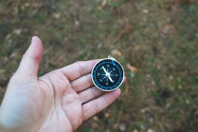 Cropped hand holding navigational compass