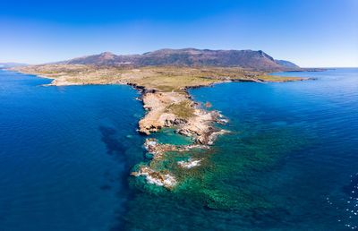 High angle view of sea against clear blue sky