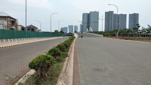 Street amidst buildings in city against sky