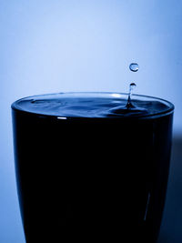 Close-up of water splashing against blue background