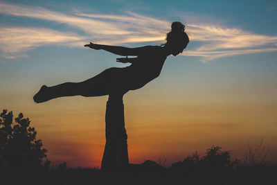 Low angle view of silhouette man against sky during sunset