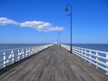 Boardwalk on beach against sky