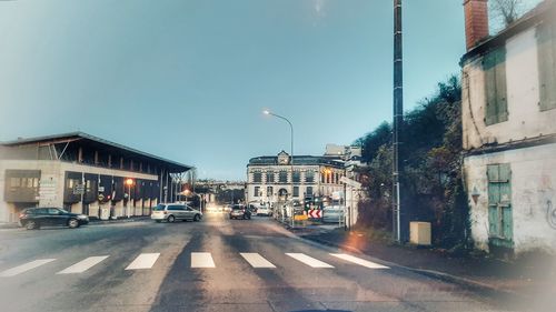 City street and buildings against sky