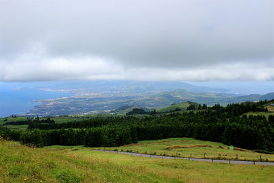 Scenic view of mountains against cloudy sky