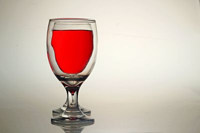 Close-up of red wine glass on table