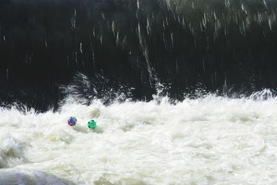 Man with ball in sea