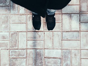 Low section of person standing on footpath