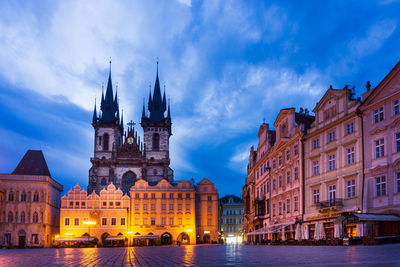 Illuminated buildings in city at dusk