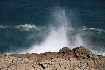 Waves splashing on rocks at shore