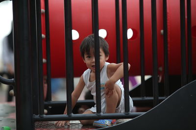 Portrait of boy sitting in playground