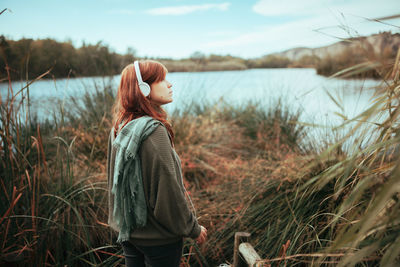 Full length of young woman standing in lake